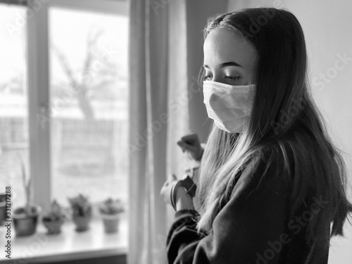 a teenage giwl wearing a medical mask during corona virus quarantine time trying to get escaped