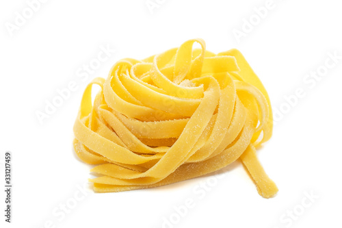 Fresh uncooked fettuccine pasta isolated on a white background