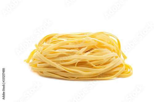 Fresh uncooked tagliolini pasta isolated on a white background