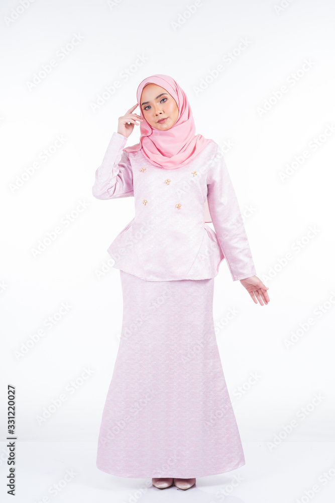Full length portrait of a beautiful female model wearing traditional dress and hijab, a lifestyle apparel for Muslim women isolated on white background. Idul Fitri and hijab fashion concept. Full length portrait of a beautiful female model wearing traditional dress and hijab, a lifestyle apparel for Muslim women isolated on white background. Idul Fitri and hijab fashion concept.