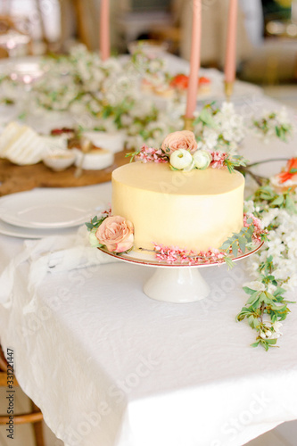 Yellow wedding cake with flowers