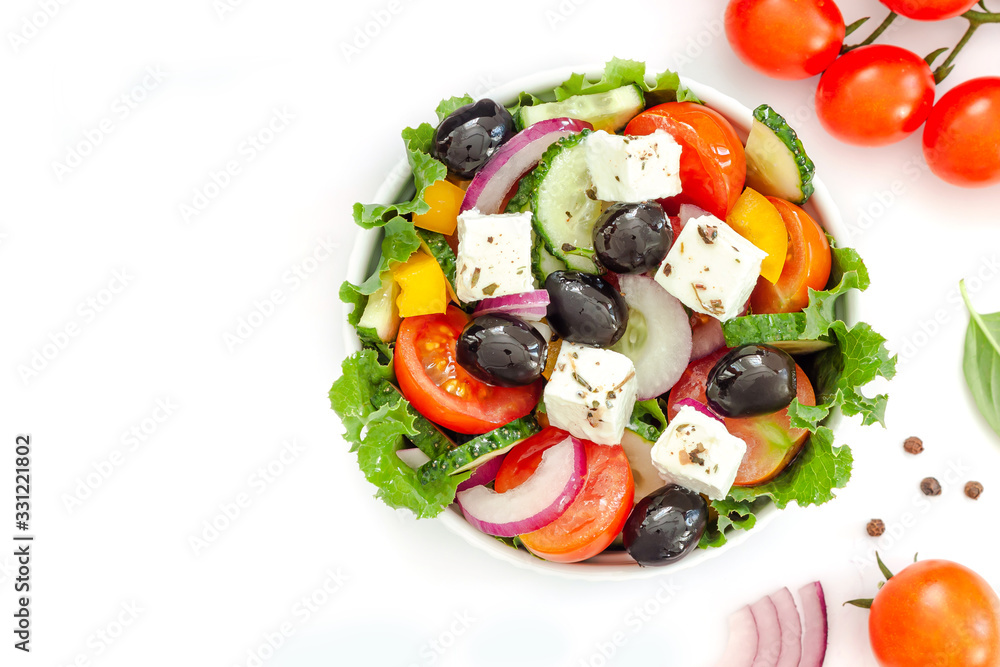 Greek salad with fresh vegetables, feta cheese and black olives on white background Greek salad with fresh vegetables, feta cheese and black olives on white background