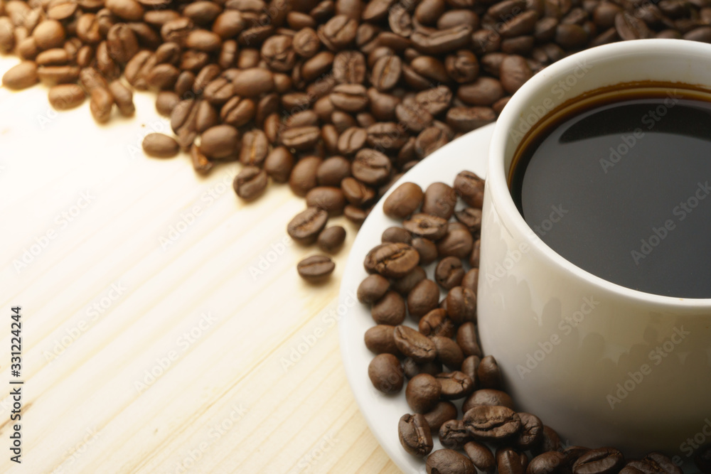 Fototapeta premium close up on coffee cup with coffee beans. free copy space for your text
