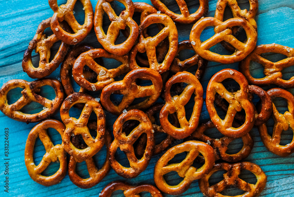Food snack Salted crispy Pretzel on blue background with copy space Food snack Salted crispy Pretzel on blue background with copy space