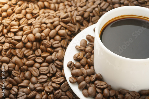 close up on coffee cup with coffee beans. free copy space for your text