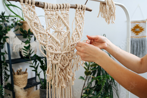 The girl's hand at macrame weaving work photo