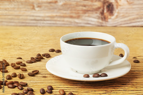 Wallpaper Mural Hot Coffee cup and beans on wood table or old wooden background Torontodigital.ca