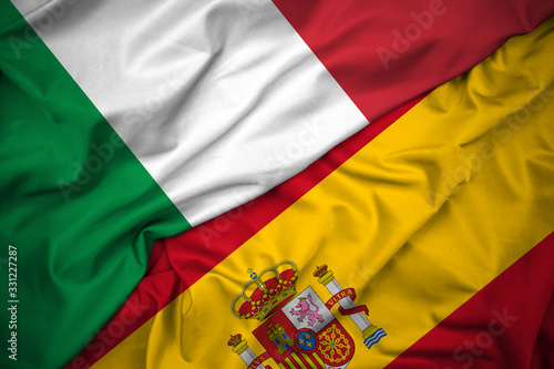 Flag of Italy and Spain Together. Relationship, International cooperation, Development, European Union and Football Rivalry Concept. Silk Fabric