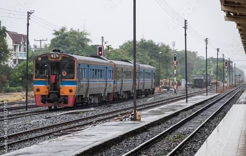 Diesel multiple units are leaving from the urban station in the rain time.