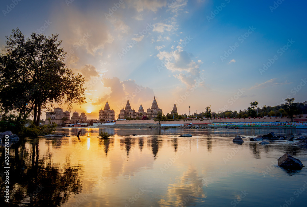 Sunset view of chhatri or canopies at Orchha from across the betwa river in Orchha Madhya Pradesh India.