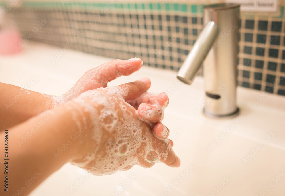 Fototapeta premium Closeup woman washing hand with soap for coronavirus protection,