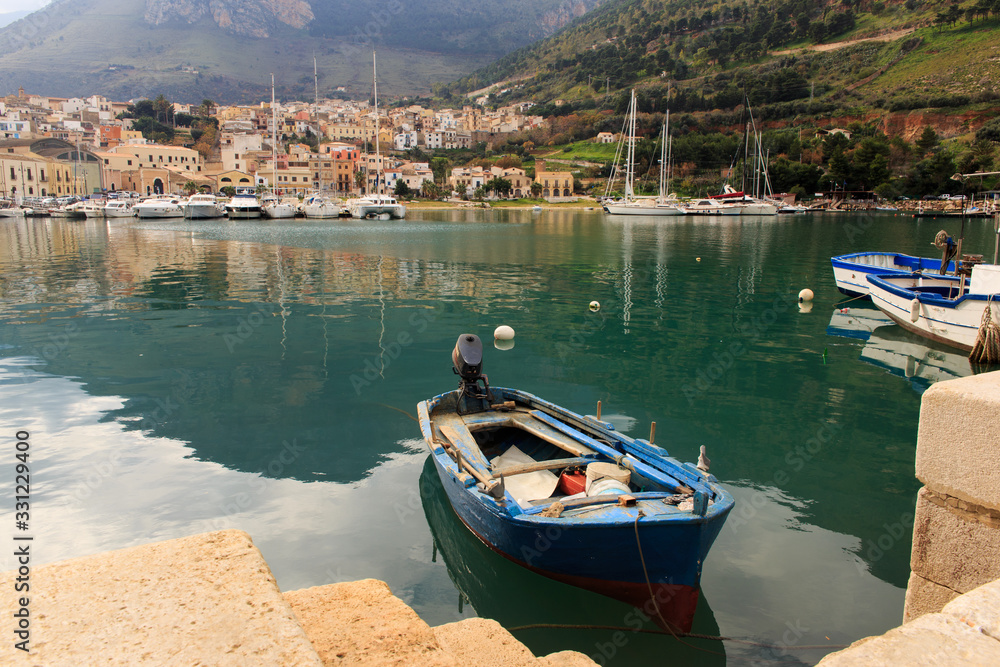 old boat in the placid waters of the port of Castellammare del Golfo / Sicily