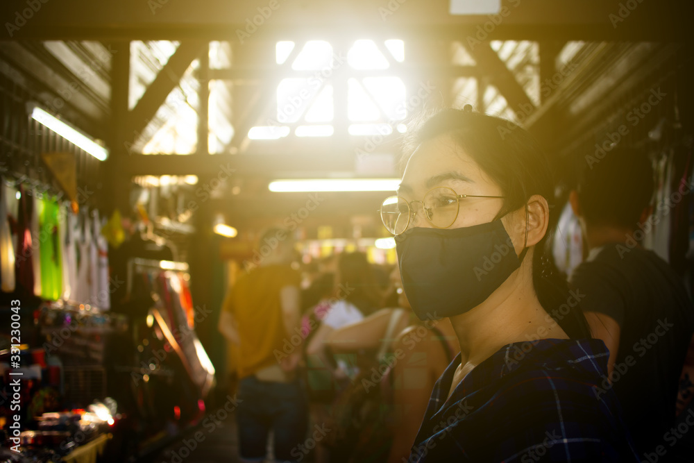 The Asian woman portrait travelling in Bangkok , Thailand by wearing the preventive mask on her face to protect her self from any illness especially Covid 19 or Corona virus spreading around the world The Asian woman portrait travelling in Bangkok , Thailand by wearing the preventive mask on her face to protect her self from any illness especially Covid 19 or Corona virus spreading around the world