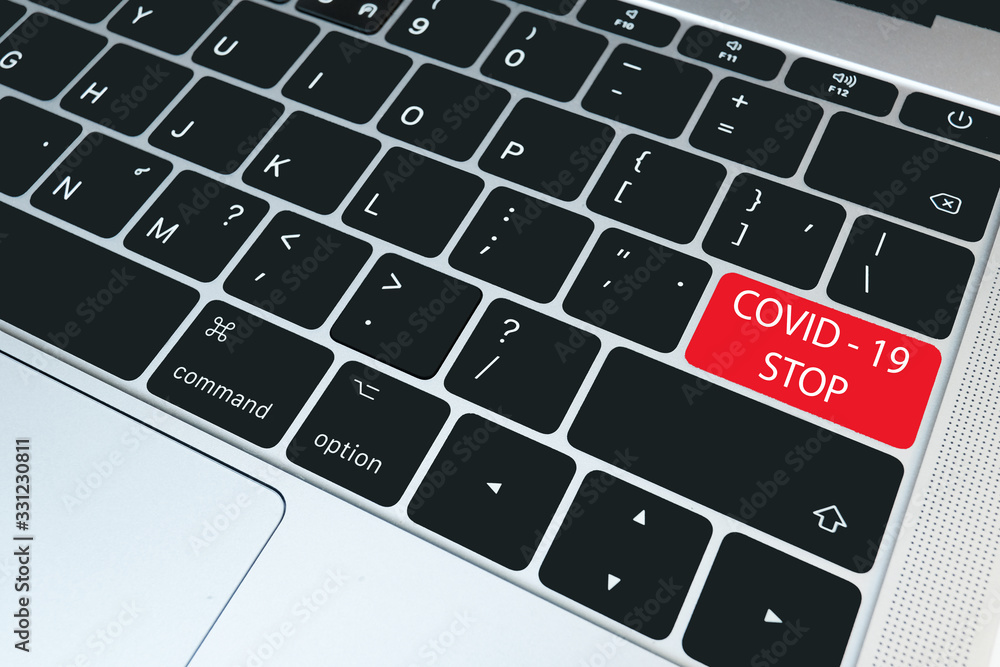 Closeup keyboard with red button-COVID-19 Stoped, Medical and technology concept Closeup keyboard with red button-COVID-19 Stoped, Medical and technology concept