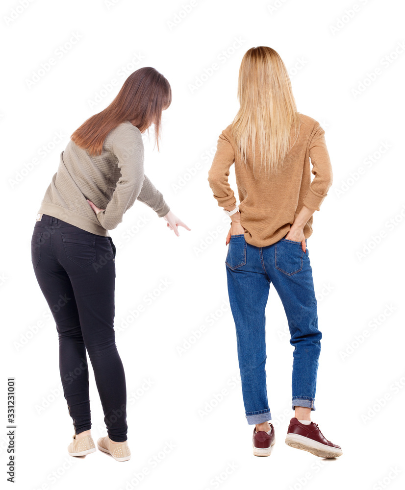 Back view of two pointing girl in sweater. Back view of two pointing girl in sweater.