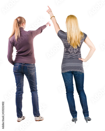 Back view of two pointing girl in sweater.