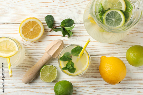 Fresh lemonade in different glasses on wooden background, top view