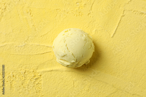 Ice cream ball on yellow background, close up