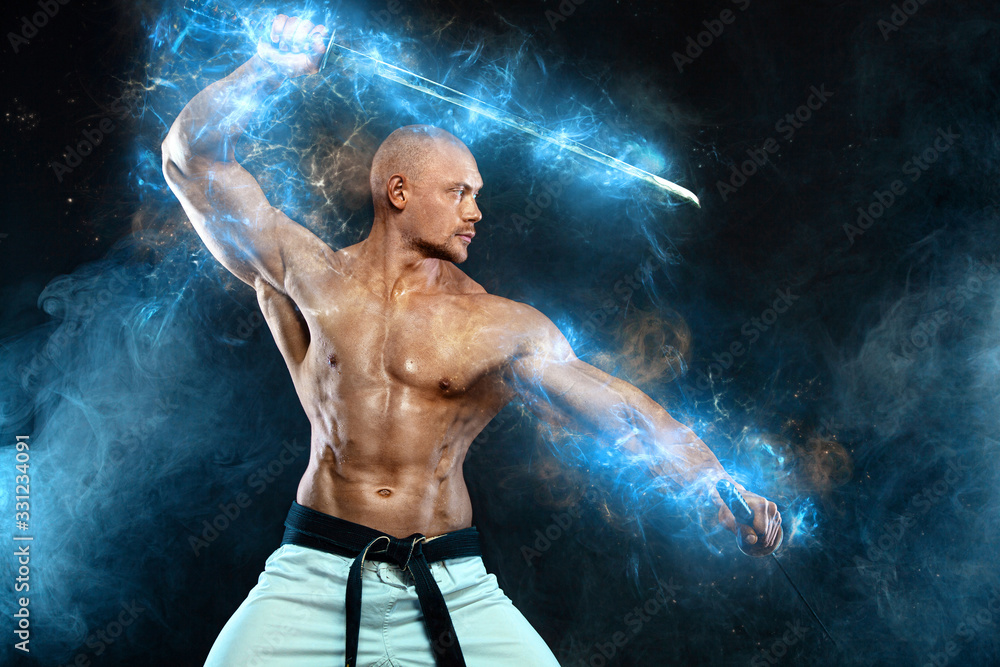 Karate fighter on black background with smoke. Shirtless man samurai