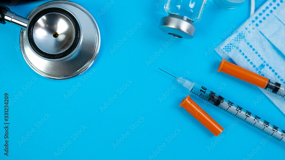 Insulin vial and syringe on blue background. Health care, doctor, clinic or hospital, medical concept. World diabetes day