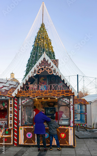 Christmas candy house and visitors on Vilnius Cathedral square Advent © Roman Babakin