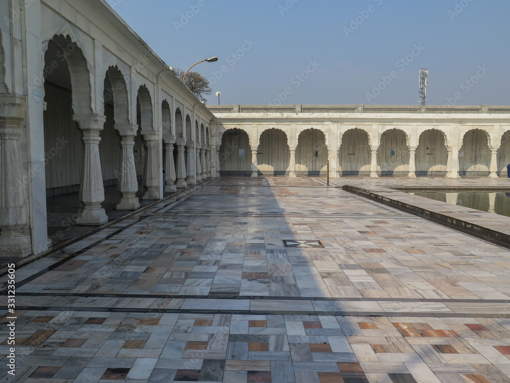 Columns and the clean floor of the Anandpur Sarovar in Anandpur Sahib, India