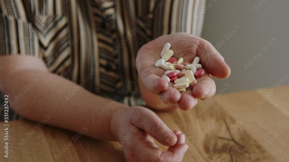 Senior woman with a bunch of the pills in her hand. Aging and health care concept Senior woman with a bunch of the pills in her hand. Aging and health care concept