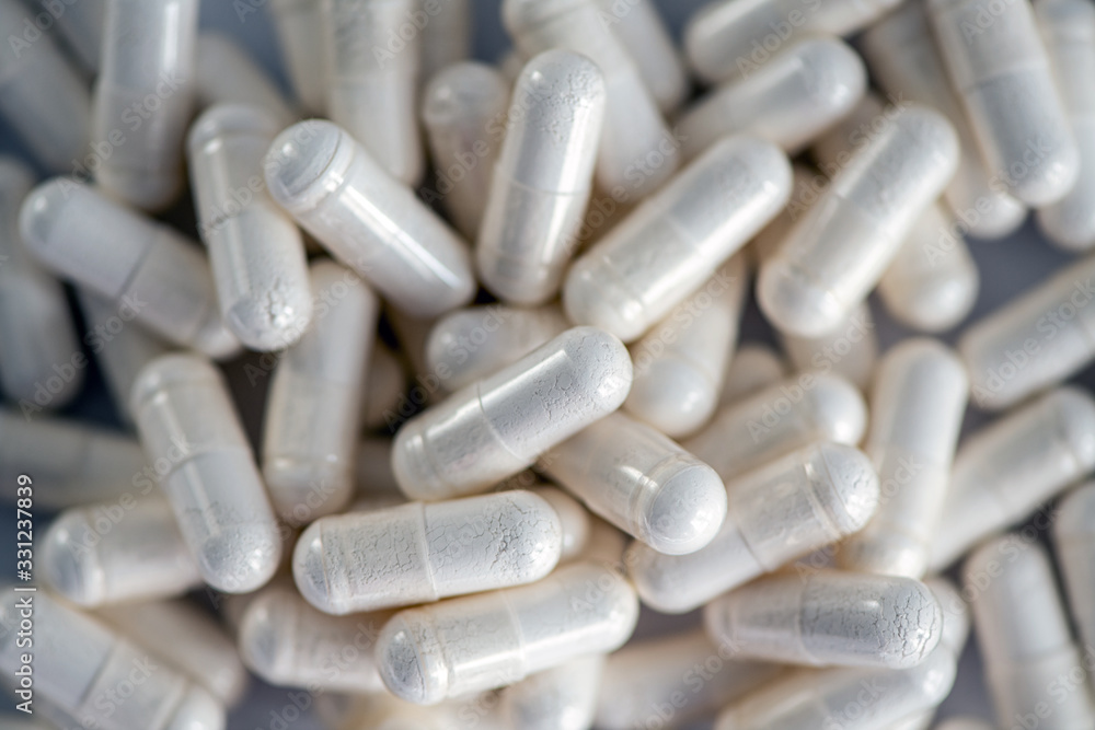 white pills with white powder close-up top view white pills with white powder close-up top view