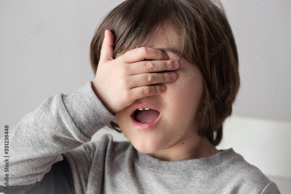 Little boy of 4 years old covered his face with hand Little boy of 4 years old covered his face with hand