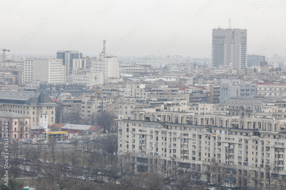 Overview of Bucharest as seen from the Palace of Parliament on a cloudy day.