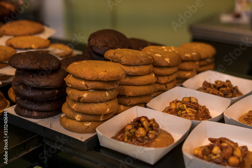 Appetizing desserts, pastries, delicious cookies are laid out in the cafeteria or bakery on the bar counter. Healthy gluten-free pastries. Horizontal view.