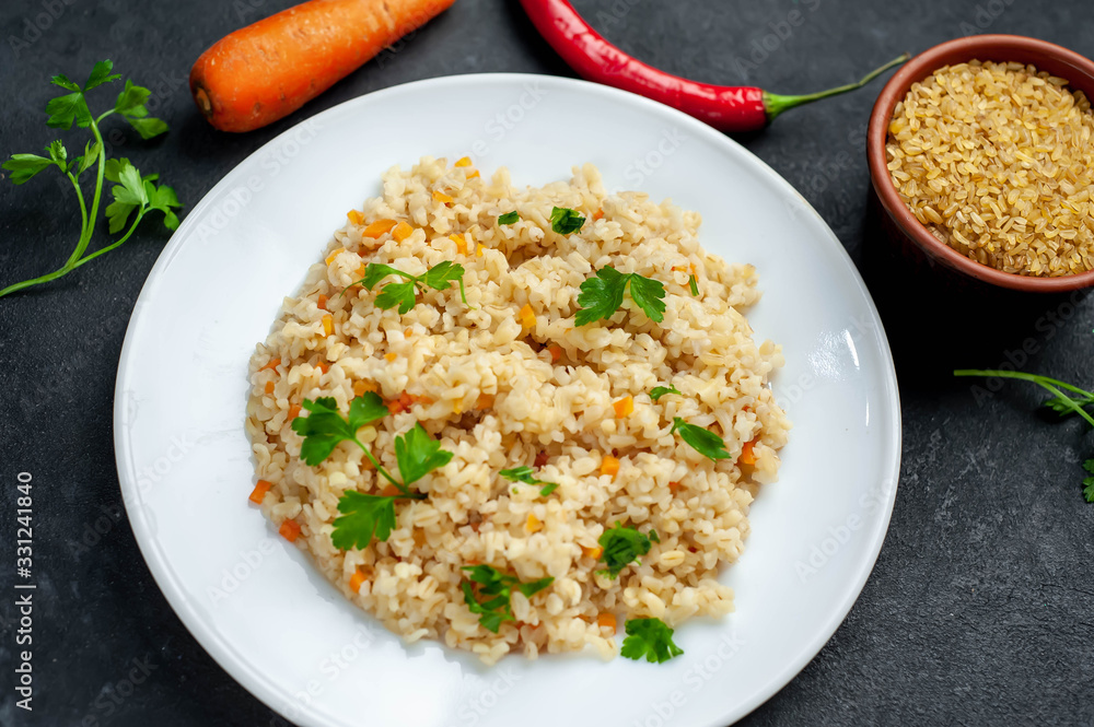 Bulgur with vegetables on a stone background. Healthy eating Bulgur with vegetables on a stone background. Healthy eating
