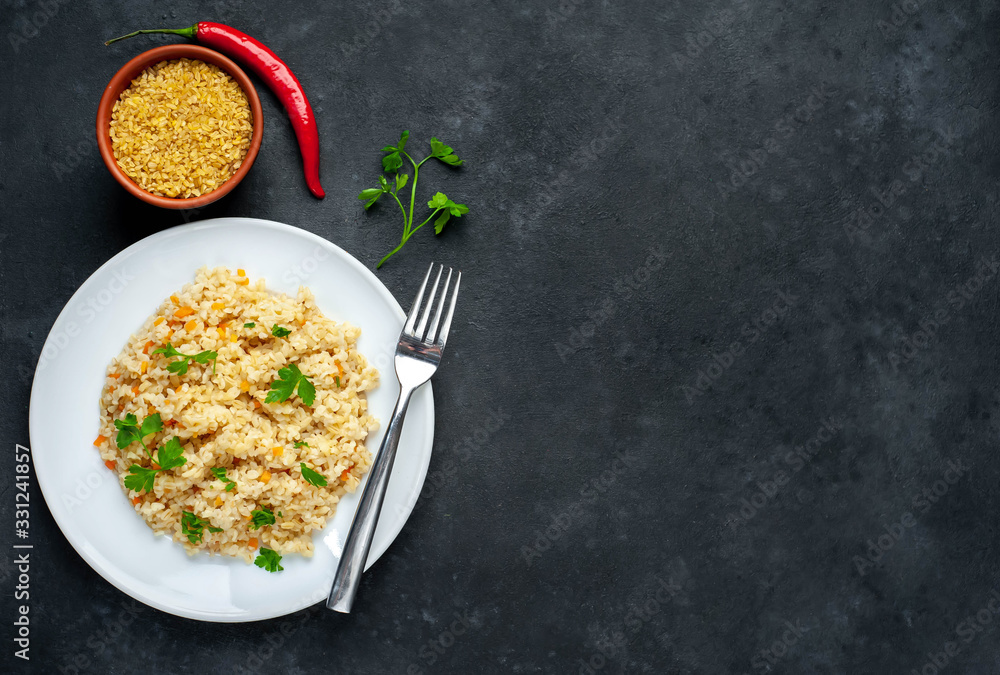 Bulgur with vegetables on a stone background with copy space for your text. Healthy eating Bulgur with vegetables on a stone background with copy space for your text. Healthy eating