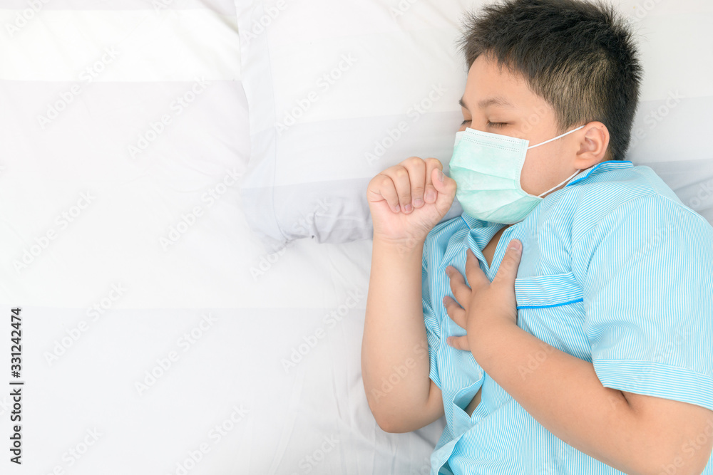 Fat boy wear surgical mask is.coughing and chest pain on bed,
