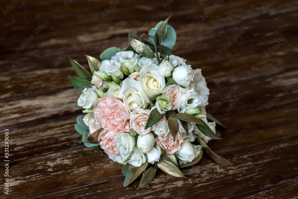 Beautiful wedding bouguet made of white and pink peonies on wooden background. wedding decoration. Bride's wedding bouquet. Fresh flower decoration Beautiful wedding bouguet made of white and pink peonies on wooden background. wedding decoration. Bride's wedding bouquet. Fresh flower decoration
