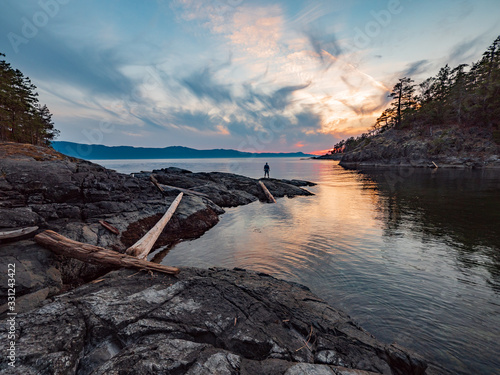 Man standing in distance in dramatic scene on the sunshine coast, British Columbia, Canada