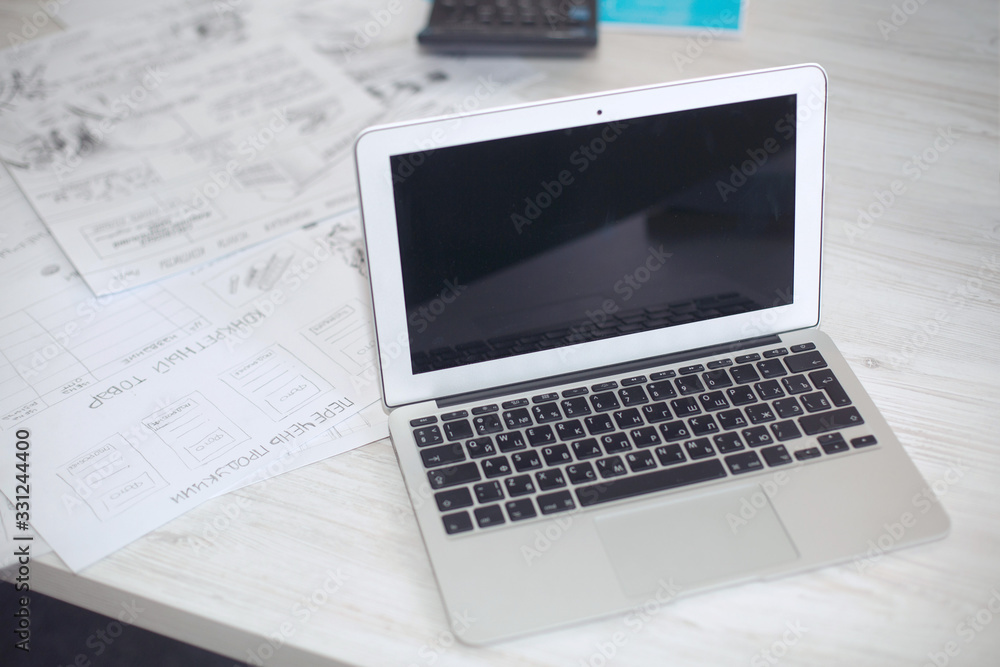 white laptop on the desk with work records with space for text. computer with blank screen in office on white background. blank study place with open laptop. work and study remotely at home. be online white laptop on the desk with work records with space for text. computer with blank screen in office on white background. blank study place with open laptop. work and study remotely at home. be online