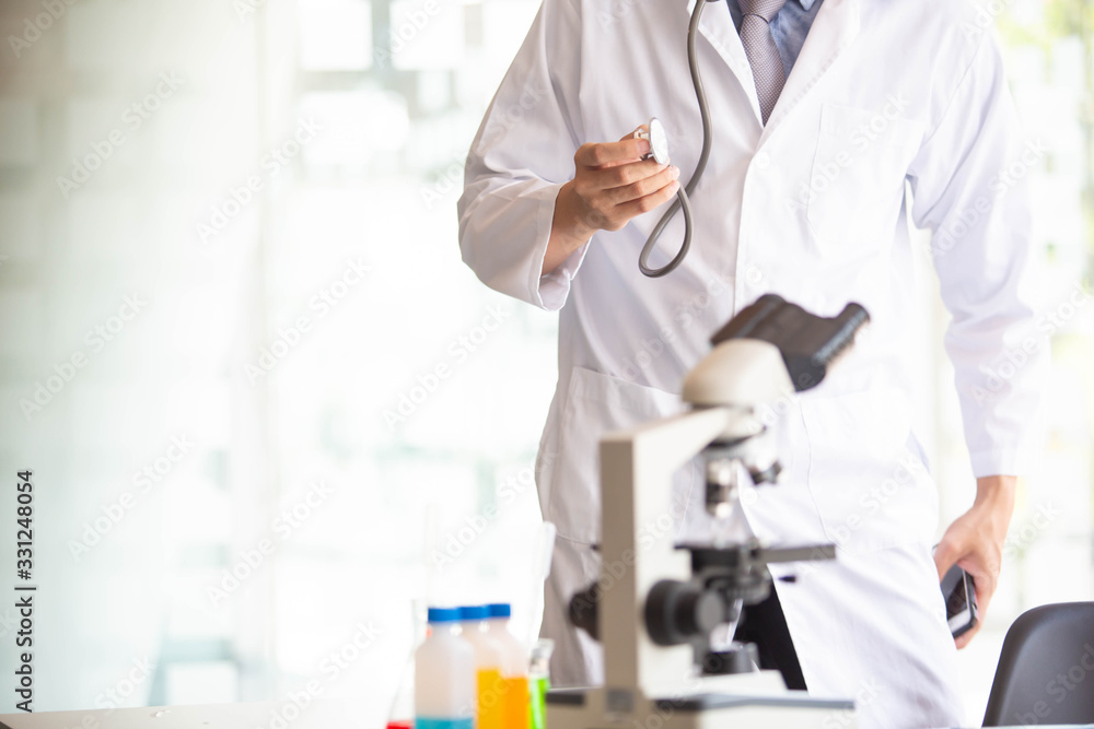 The doctor is testing a sample of biological tubes contaminated by Corona-virus Covid 19 and searching for a vaccine or Syrup against the virus. In the laboratory and film samples of infected lung The doctor is testing a sample of biological tubes contaminated by Corona-virus Covid 19 and searching for a vaccine or Syrup against the virus. In the laboratory and film samples of infected lung