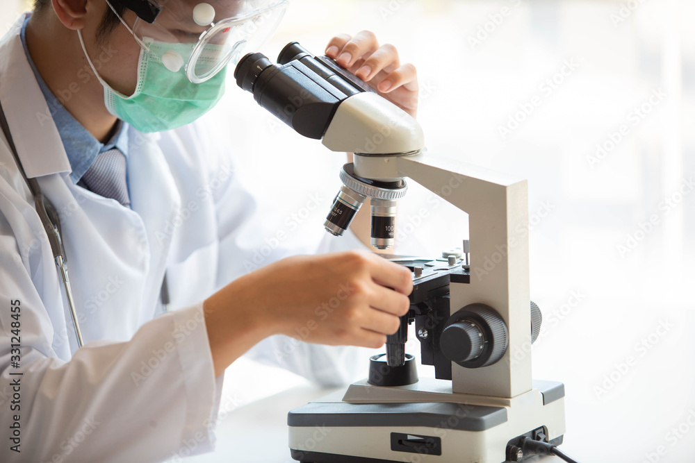 The doctor is testing a sample of biological tubes contaminated by The doctor is testing a sample of biological tubes contaminated by