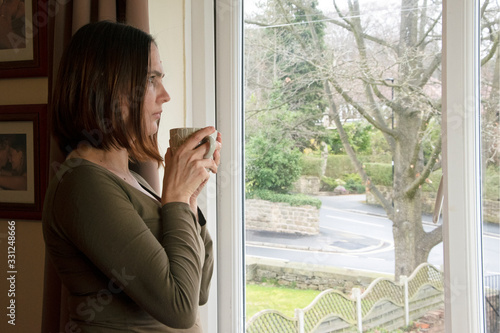 Woman stares out of window