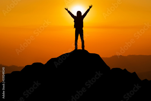 The silhouette of the man who successfully climbed the top of the mountain