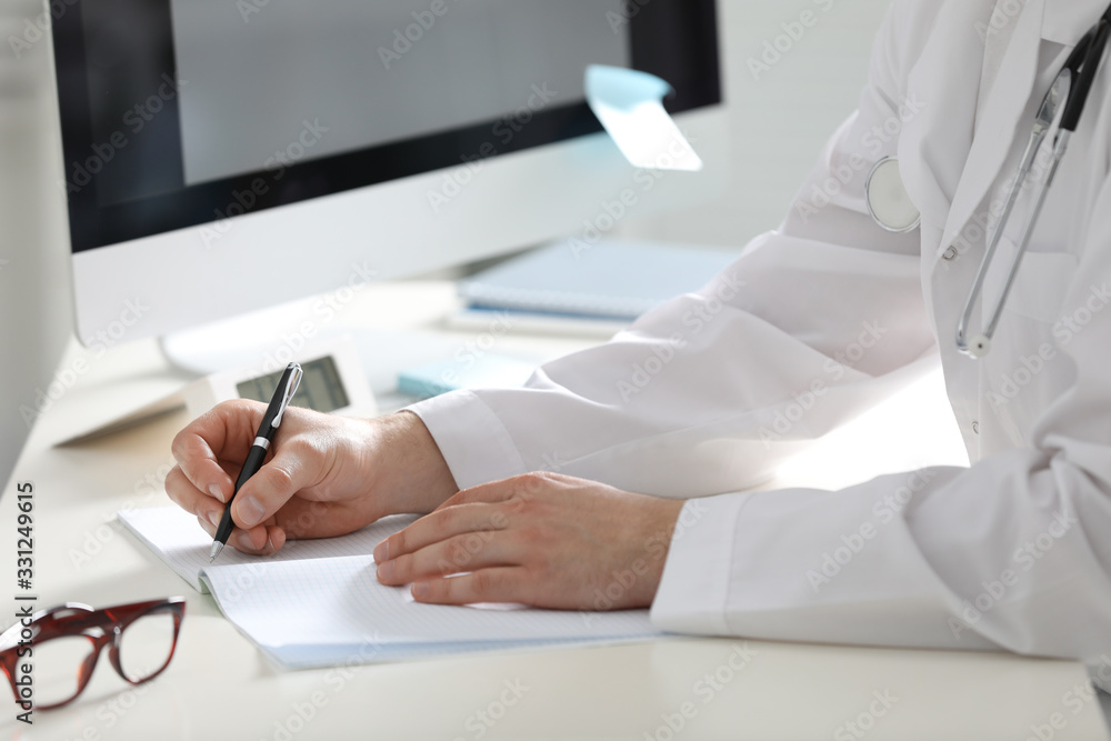 Doctor working at desk in office, closeup Doctor working at desk in office, closeup