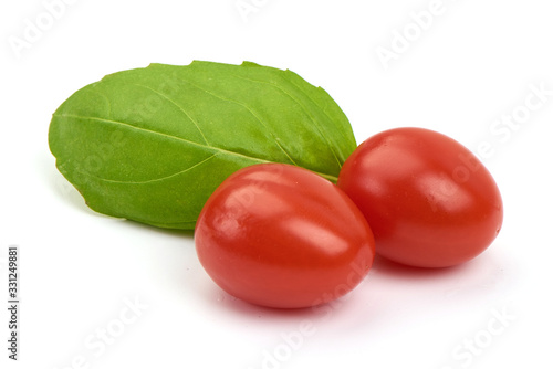 Fresh cherry tomatoes with Sweet basil leaves, isolated on white background