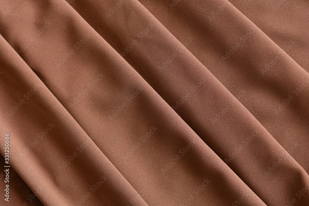 Fototapeta premium Soft light brown folded fabric for background.