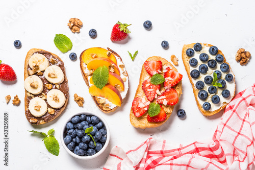 Wallpaper Mural Sweet toast assortment with fresh fruit and berries on white. Torontodigital.ca