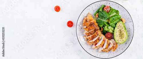 Trendy salad. Chicken grilled fillet with salad fresh tomatoes and avocado. Healthy food, ketogenic diet, diet lunch concept. Keto/Paleo diet menu. Top view, overhead, banner photo