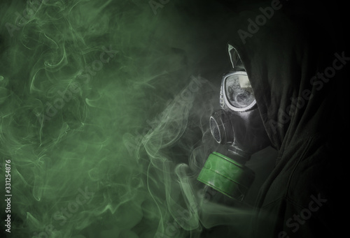 Man in a gas mask in the toxic smoke photo