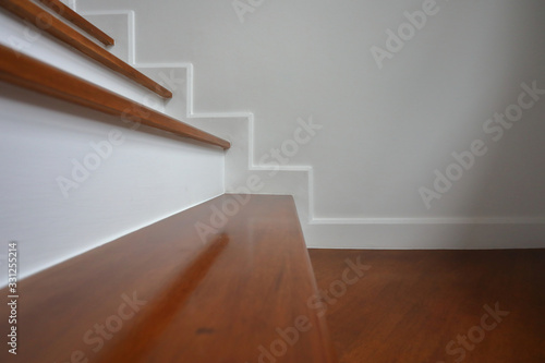 brown wooden stair and white wall in residential house