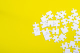 White jigsaw puzzle on a yellow background