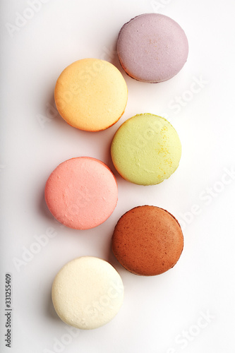 Macaroni cookies of different colors on a white background, isolate.